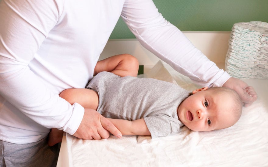 A physical therapist does shoulder exercises for a baby with a brachial plexus injury.