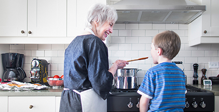 Grandmother cooking with grandchild.