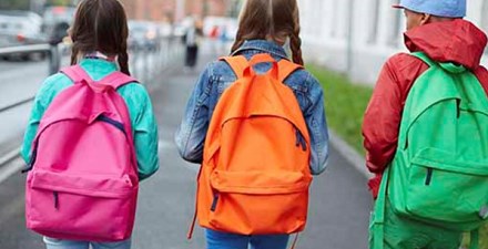 Kids walking with backpacks.