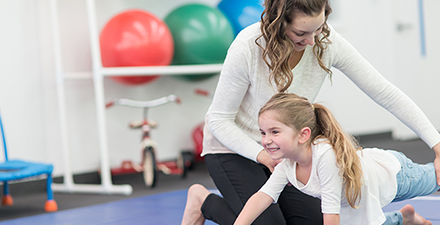 Physical therapist working with a child