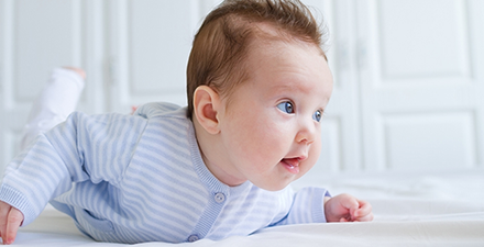 Baby on stomach for tummy time.